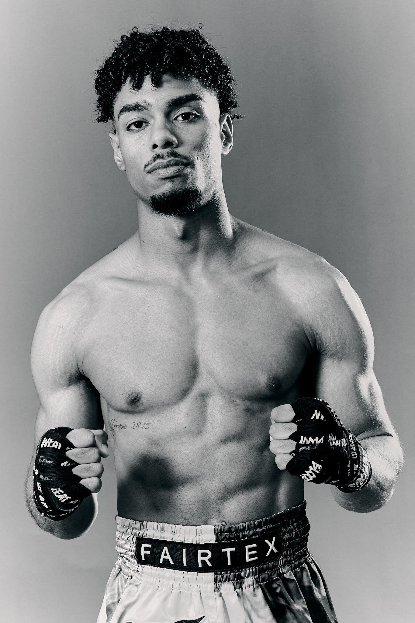 Boxer wearing gloves and posing confidently