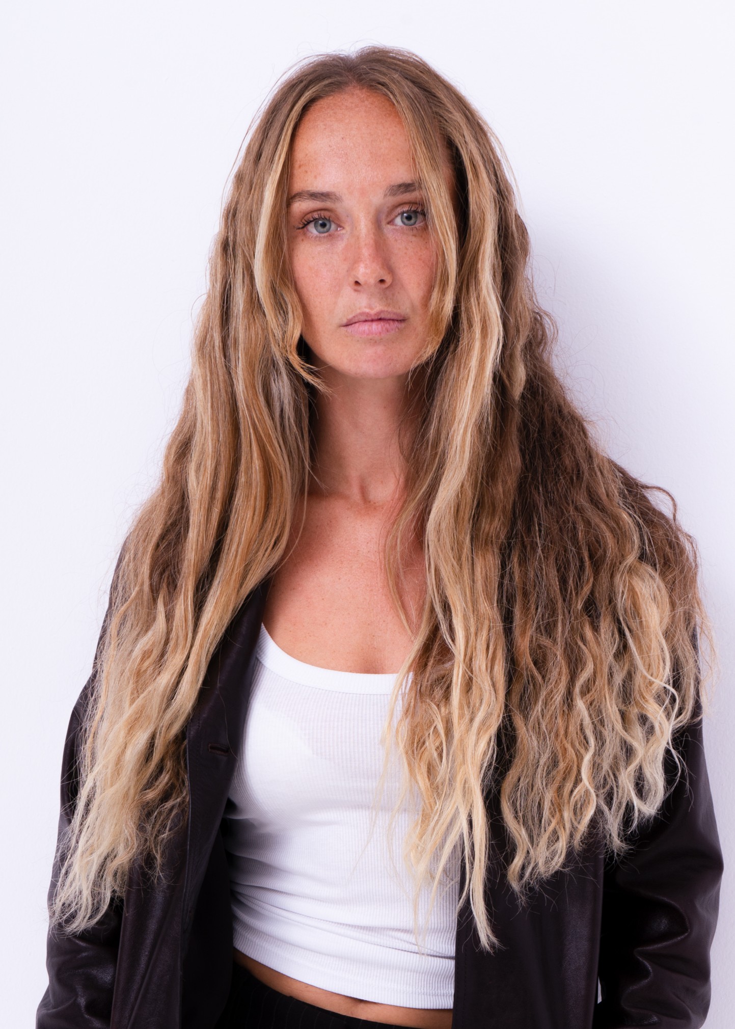 Woman with long wavy hair and leather jacket
