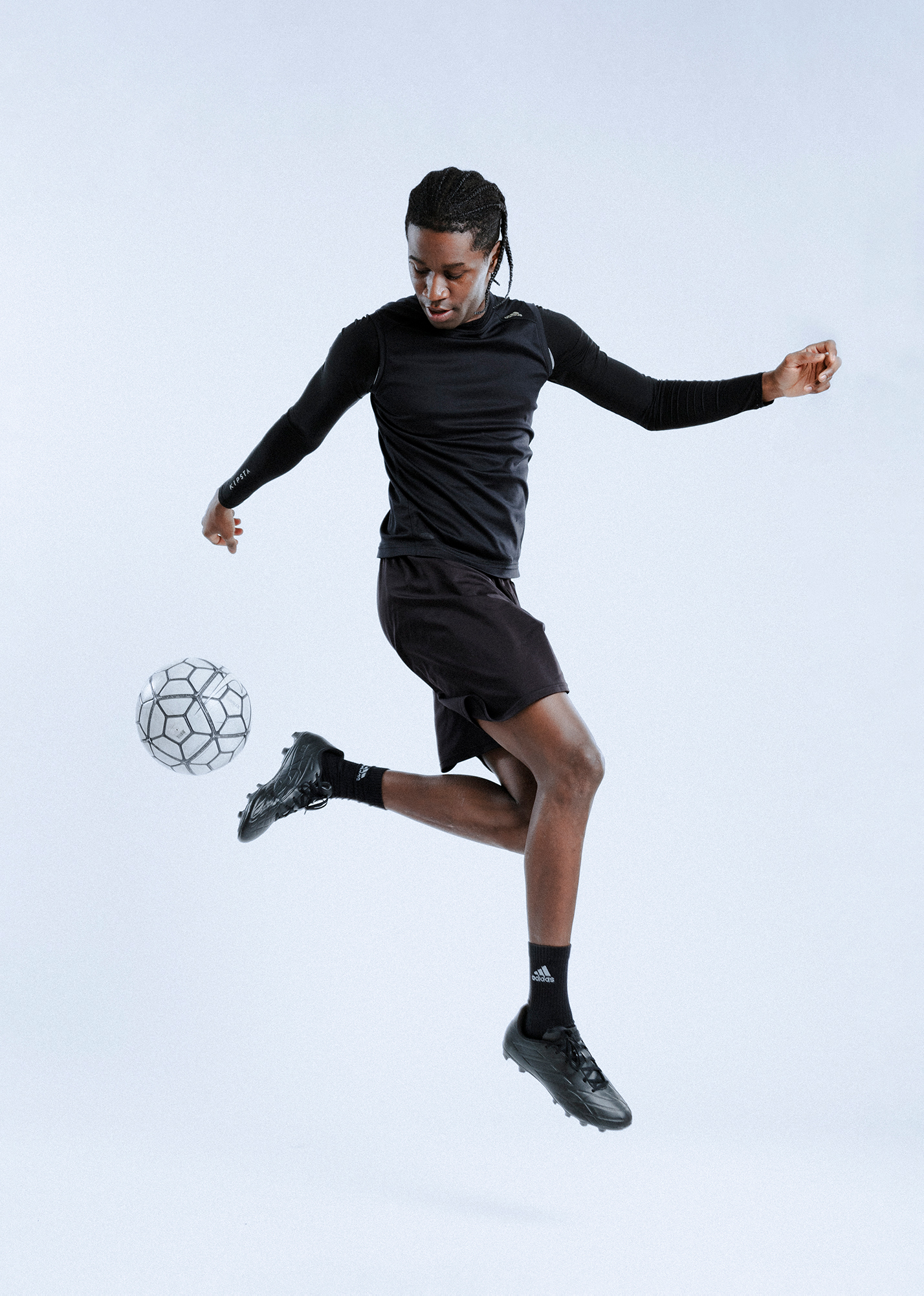 Soccer player kicking ball mid-air