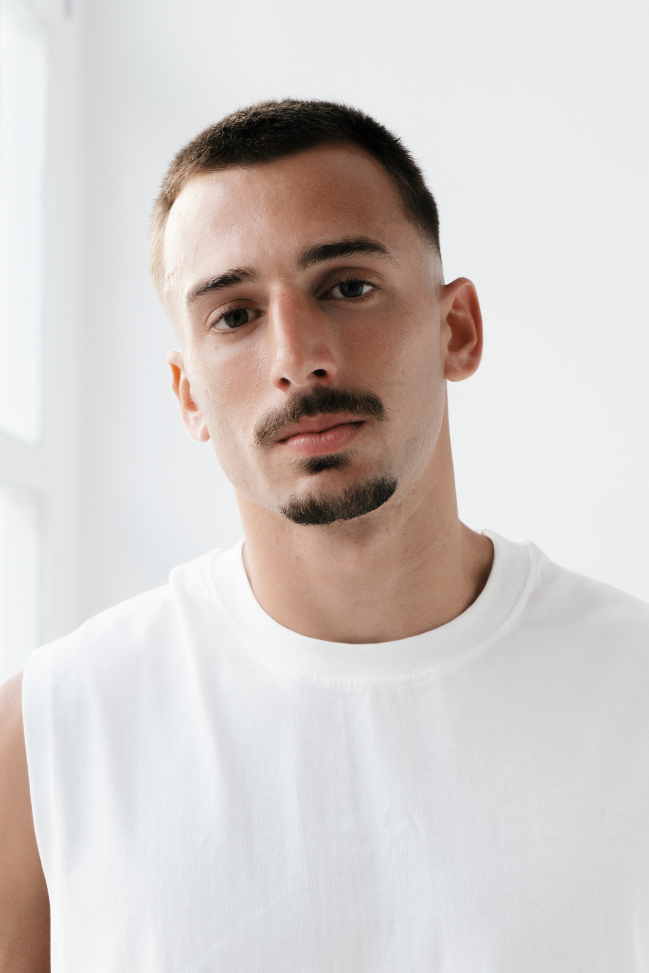 Man in white sleeveless shirt portrait
