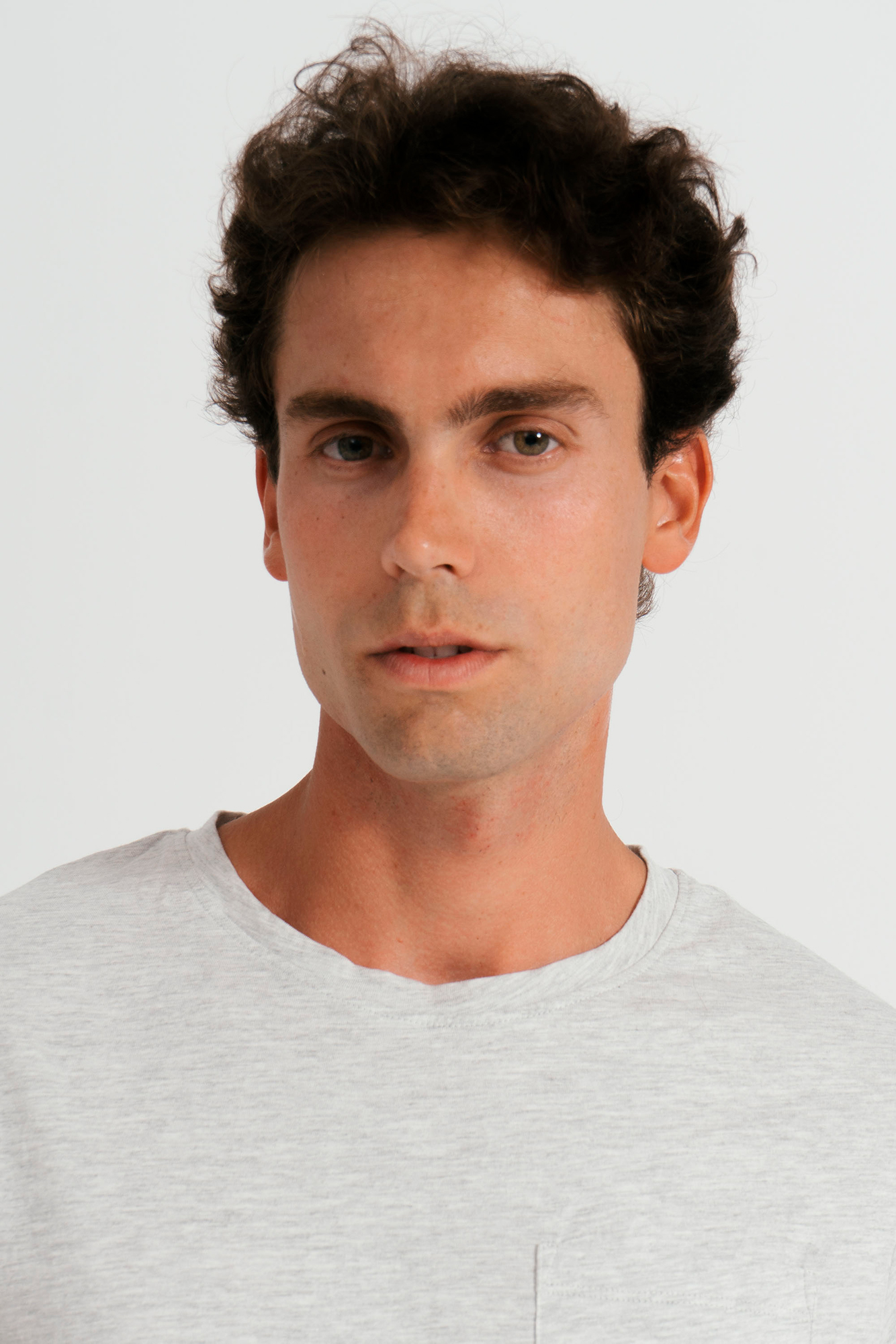 Portrait of a man in gray shirt.