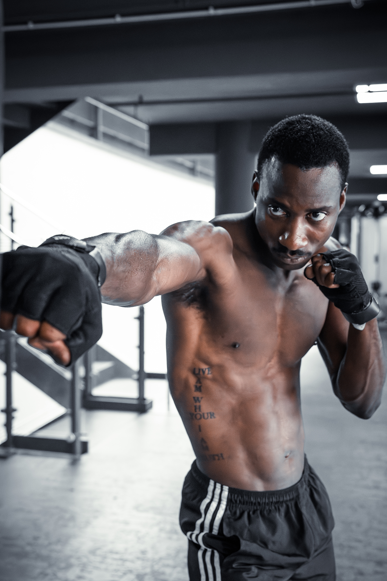 Man practicing boxing in a gym setting.