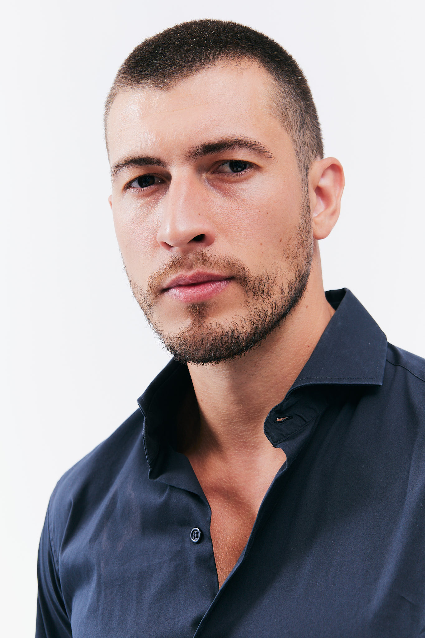 Man in dark shirt with short hair