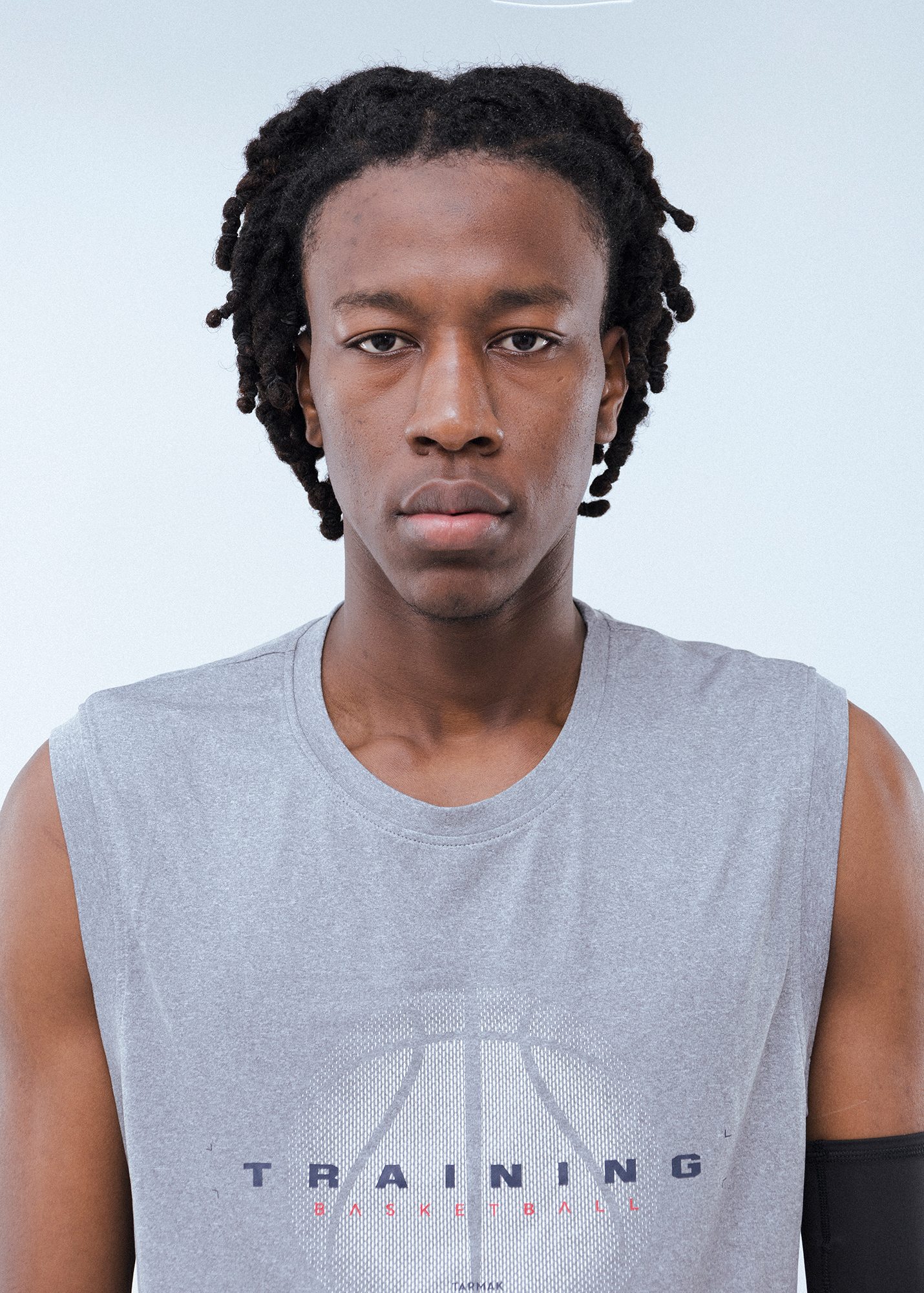 Person wearing gray sleeveless training shirt.