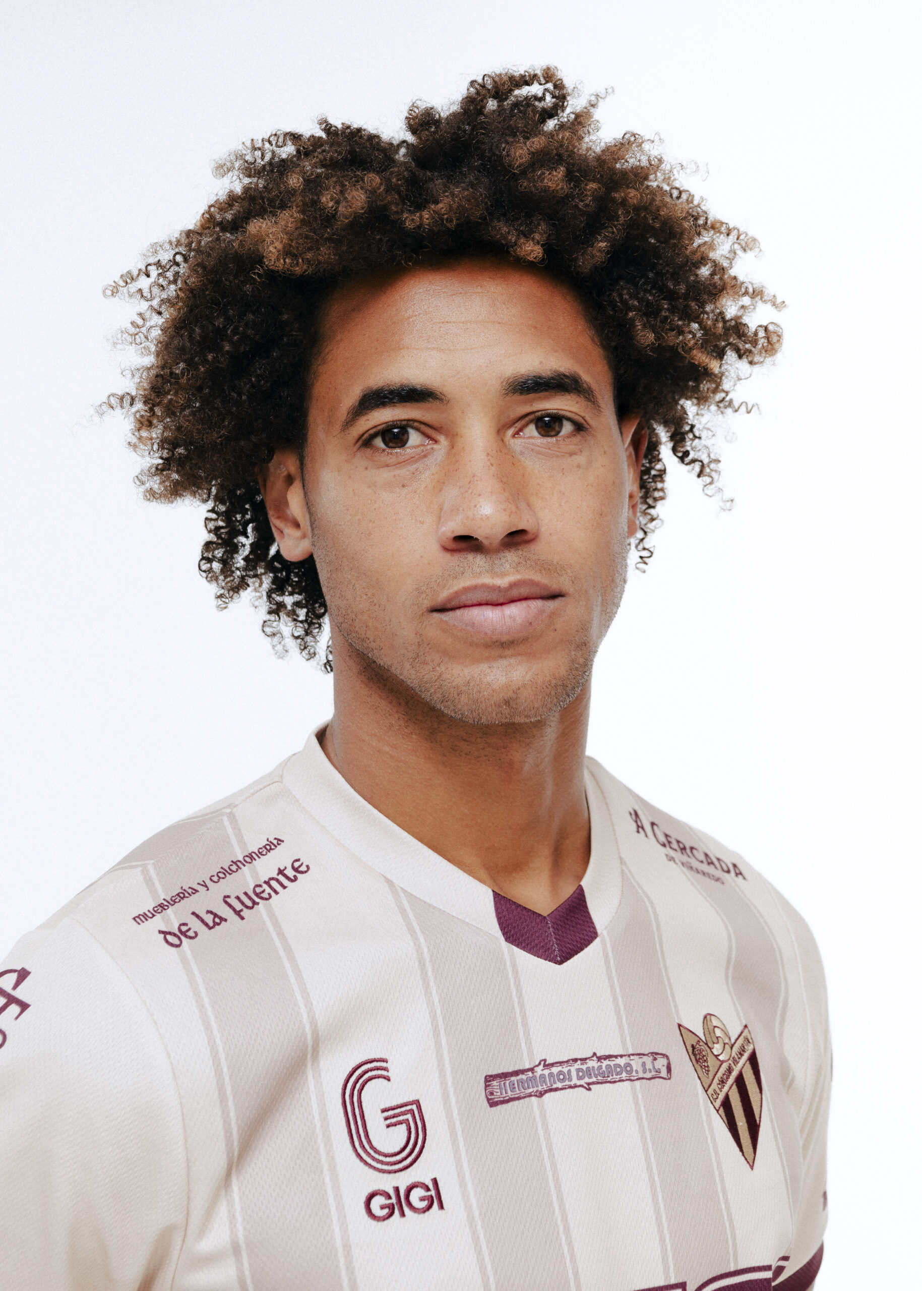 Soccer player in white jersey on white background.