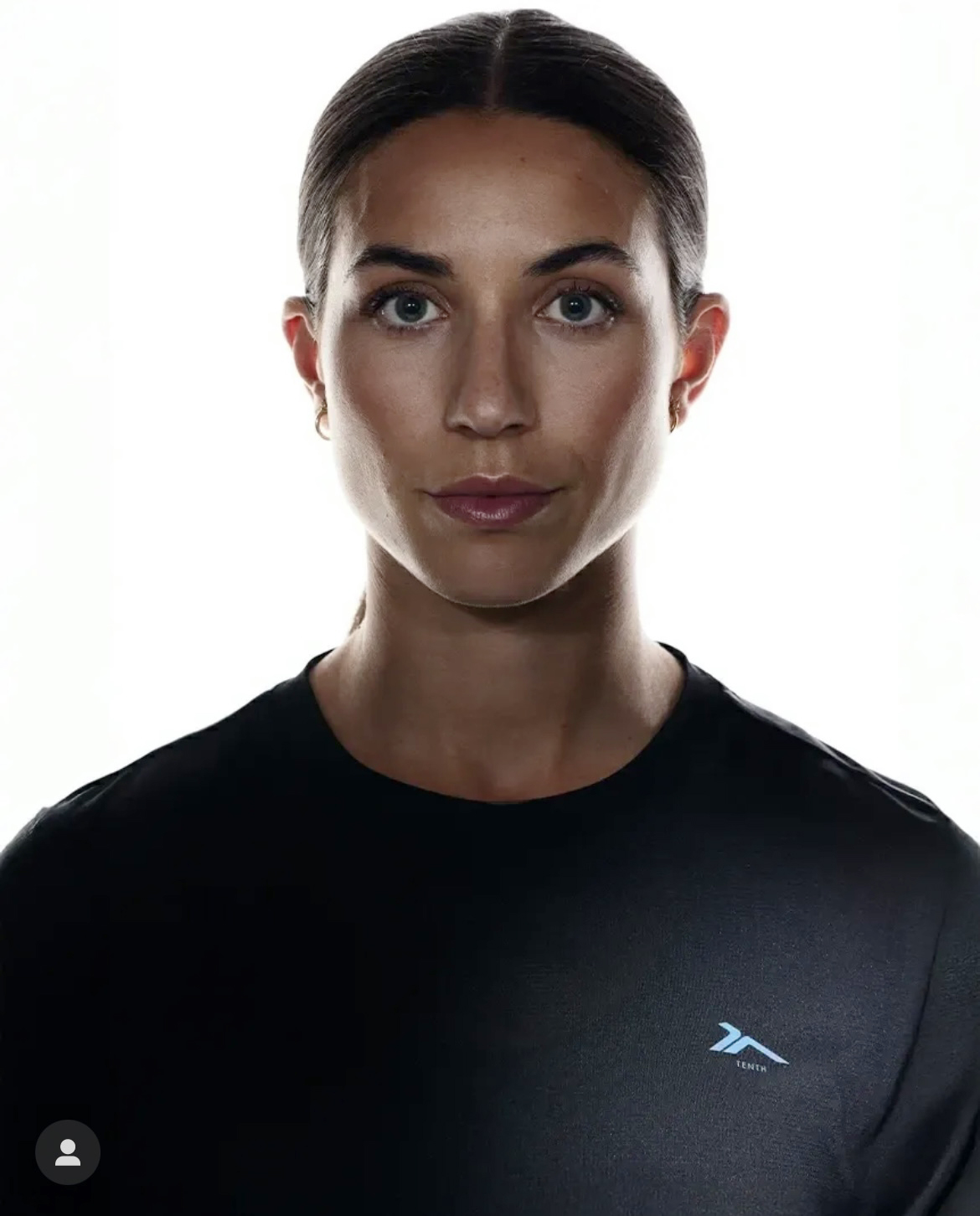 Person in black shirt, well-lit portrait photo.