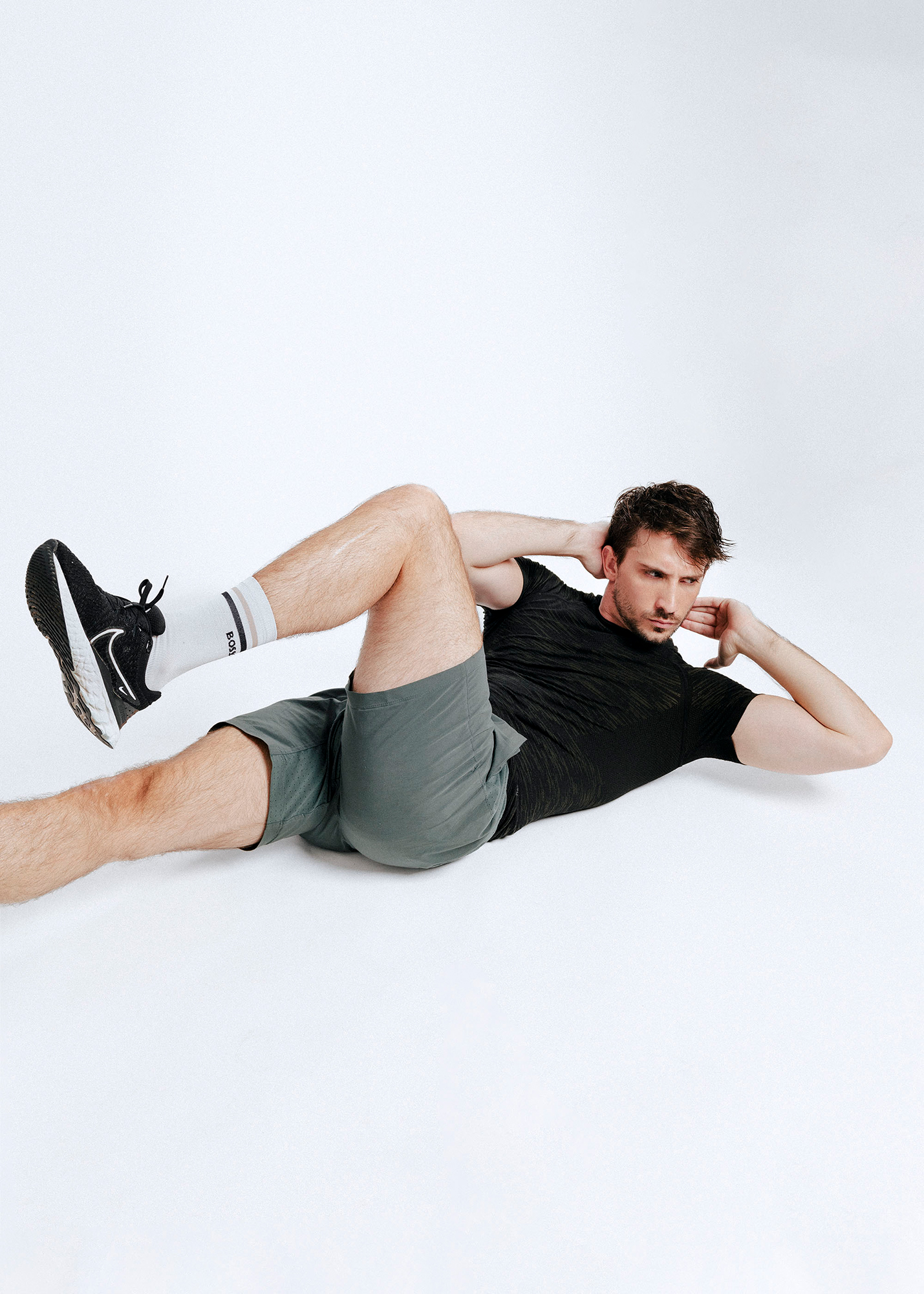 Man doing bicycle crunch exercise on floor