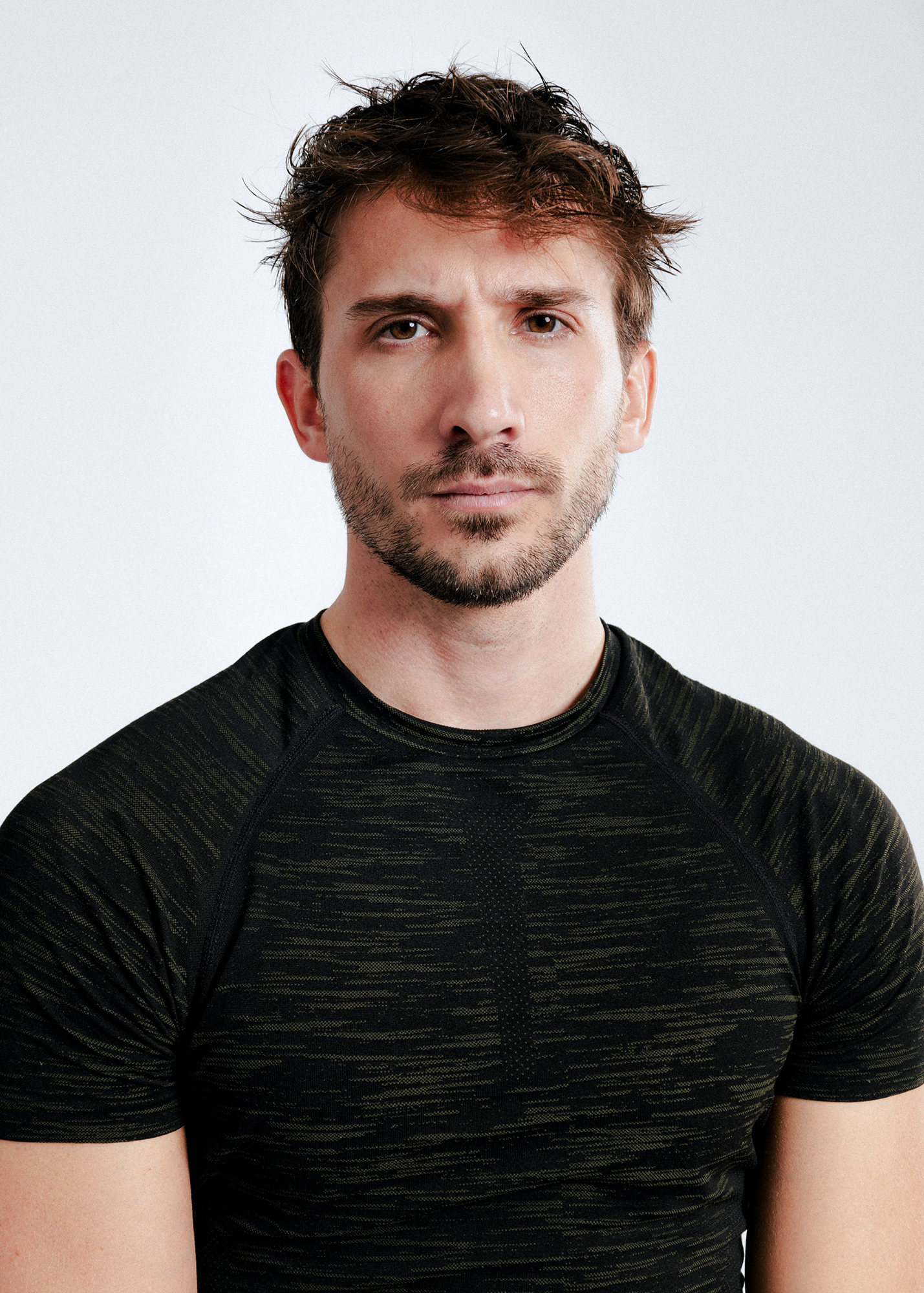 Man in black shirt looking into camera