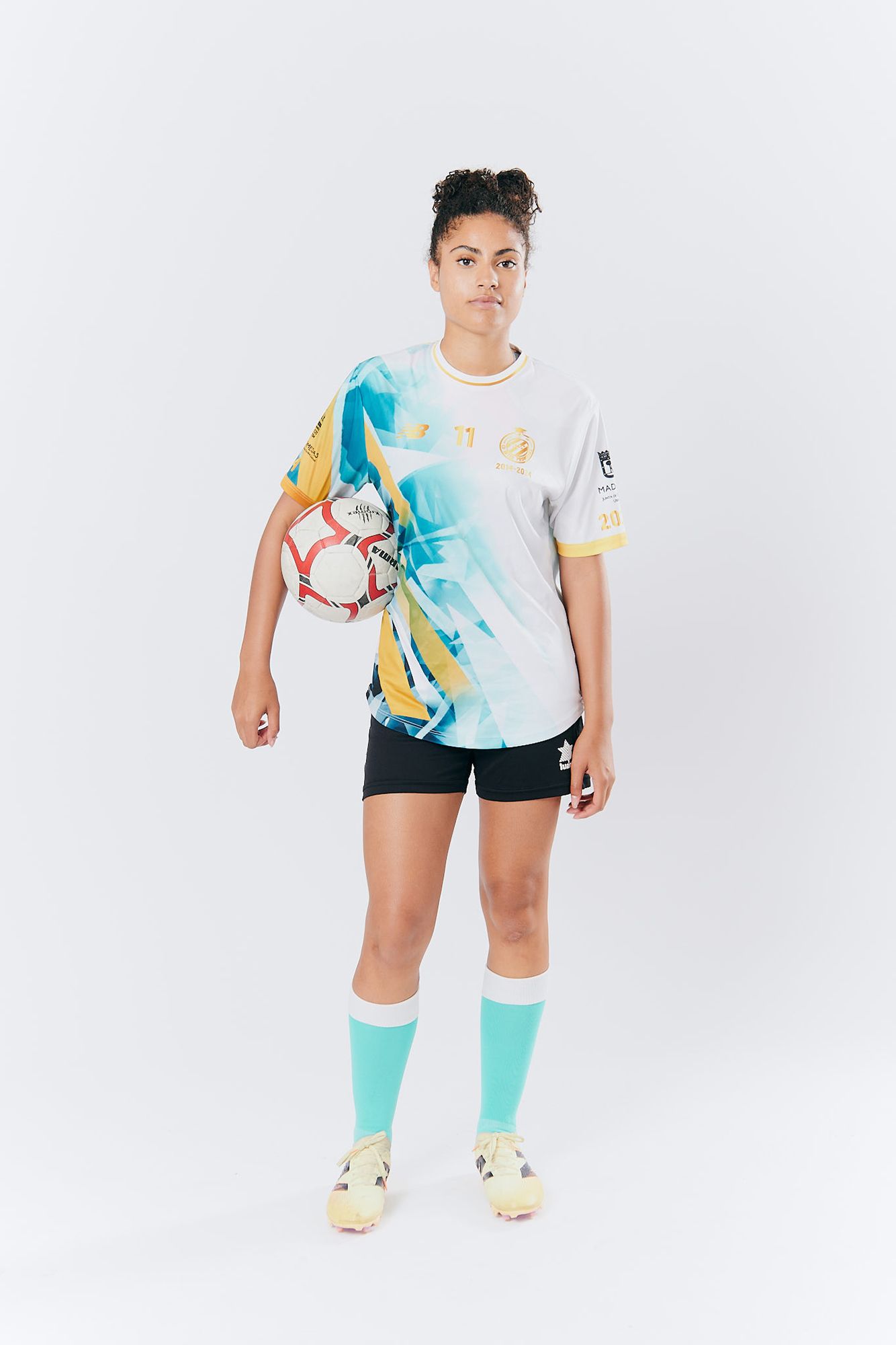Soccer player in colorful uniform holding ball