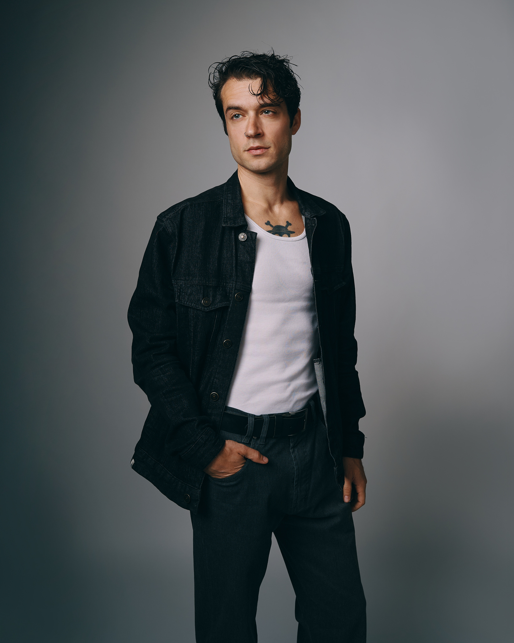 Casual man in denim jacket posing confidently