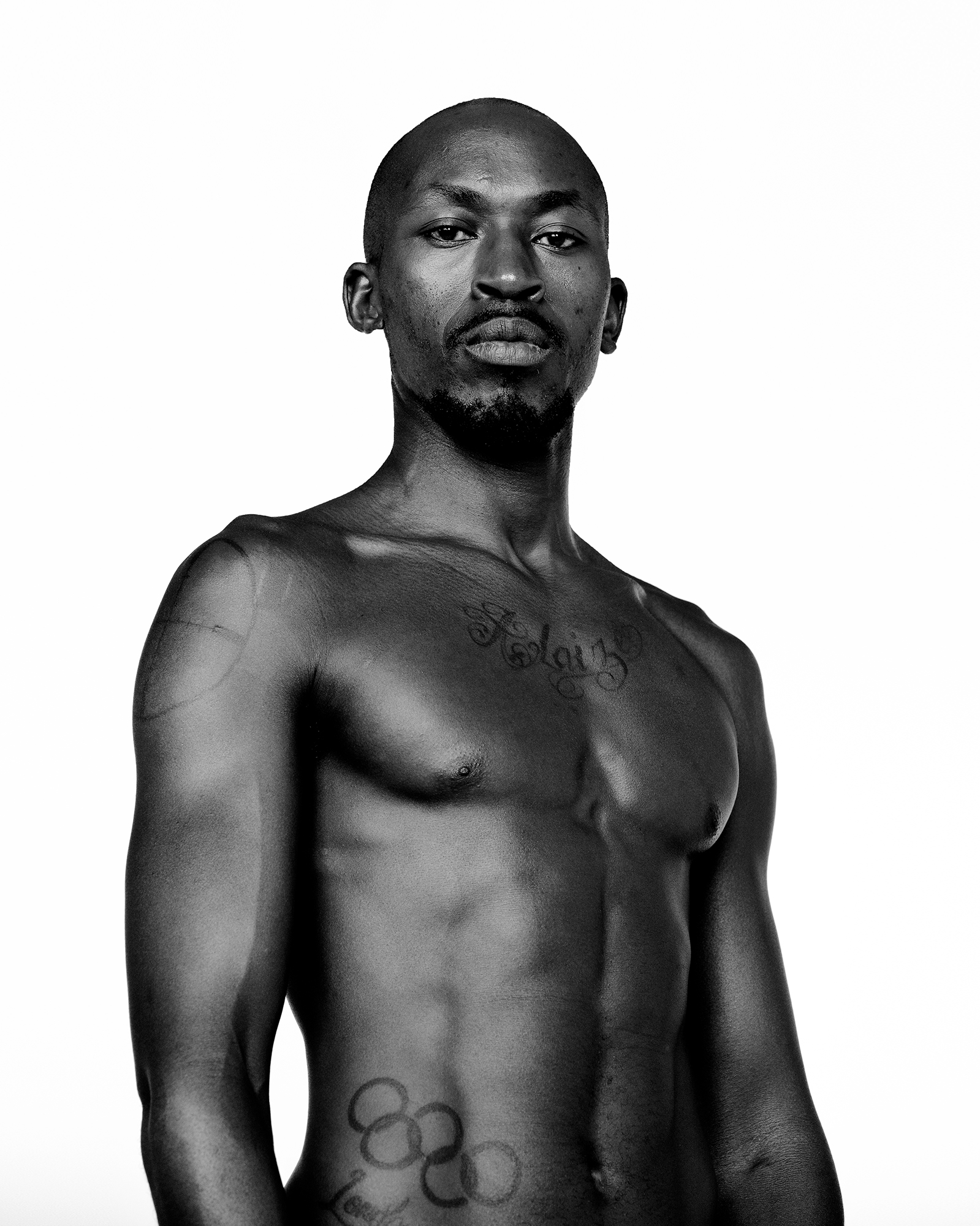 Black and white portrait of tattooed person.