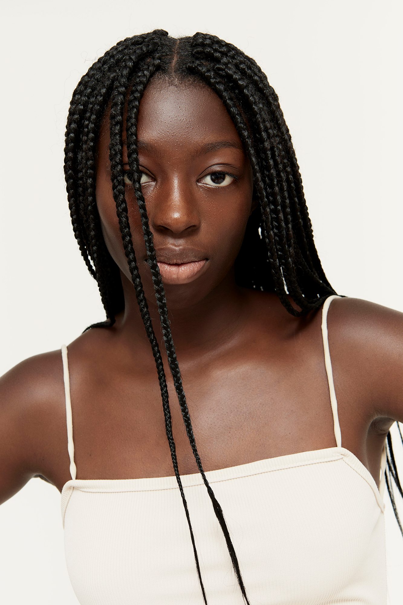 Woman with braided hair wearing white top
