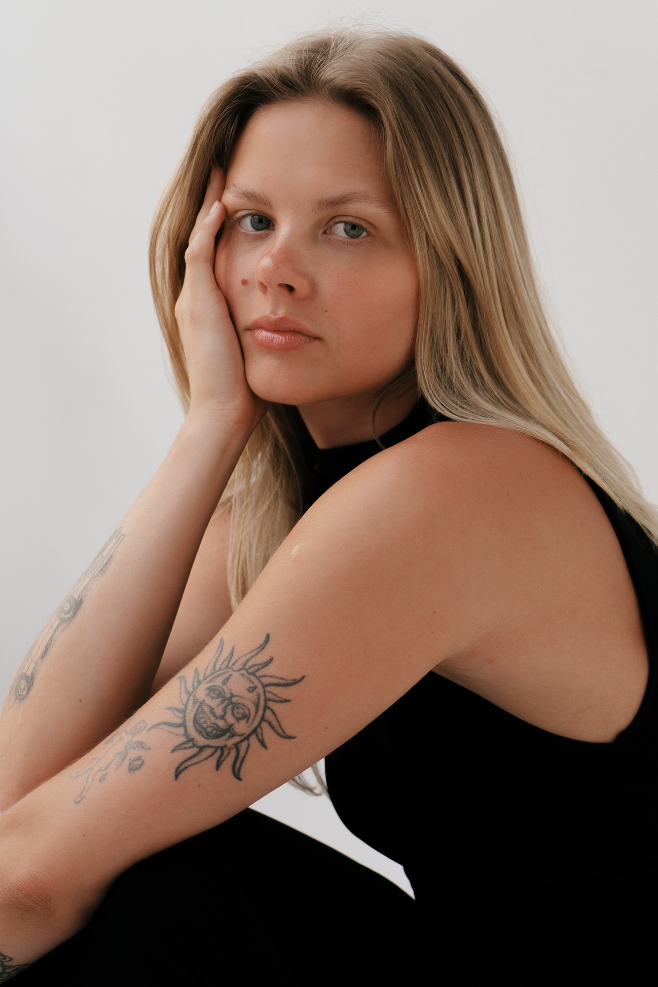 Woman with sun tattoo on her arm