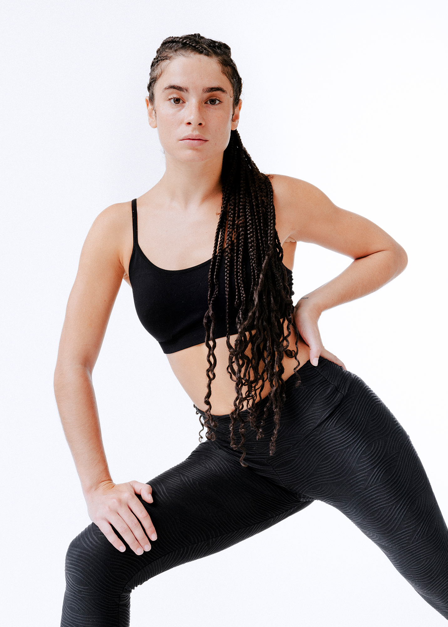 Woman posing in athletic wear, white background