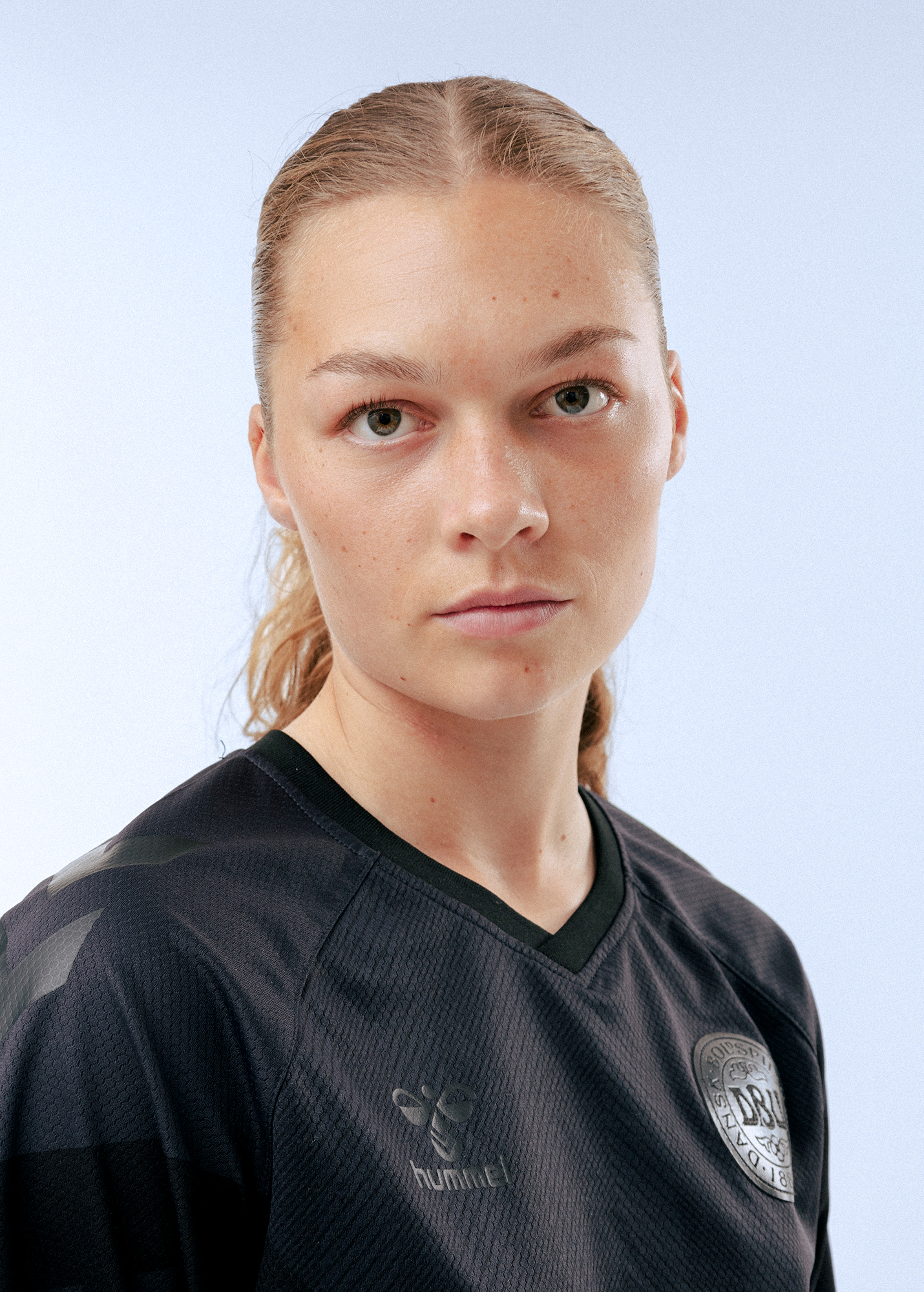 Person in black sports jersey, neutral expression