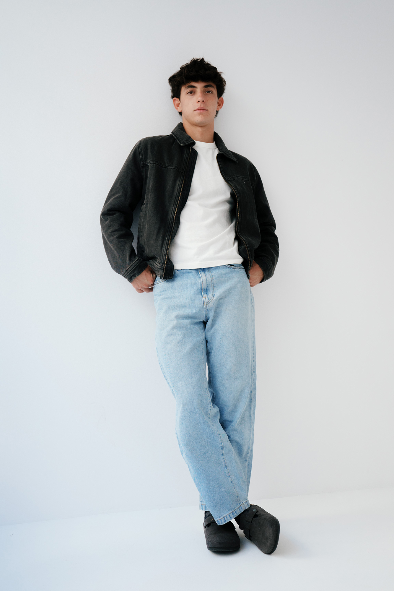 Person in casual denim and jacket outfit.