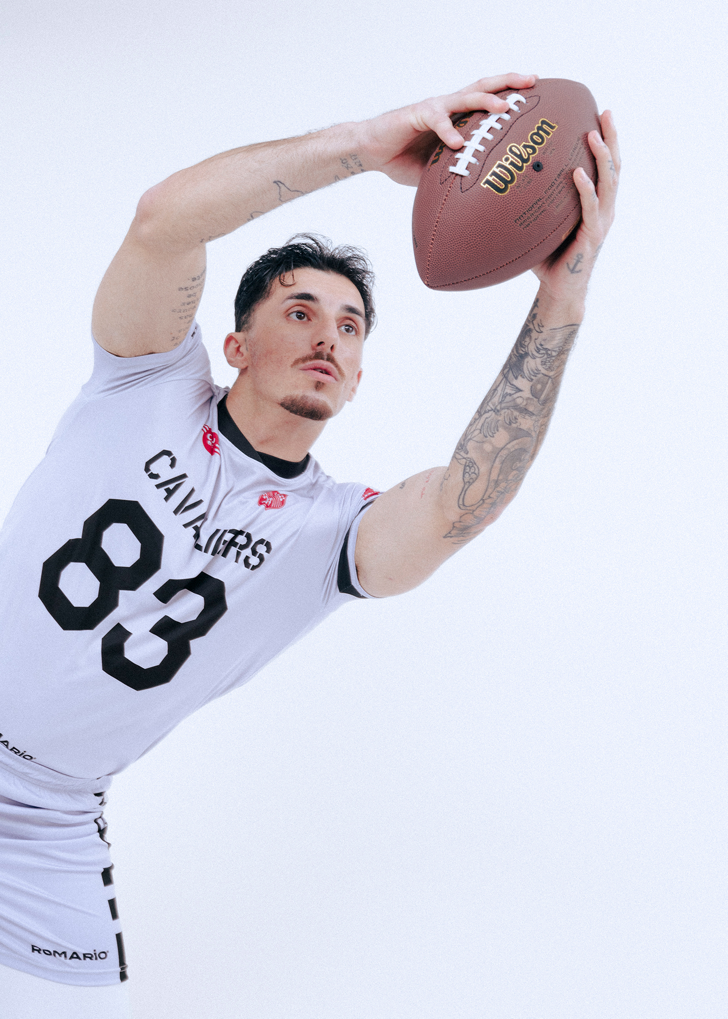 Football player catching ball mid-air