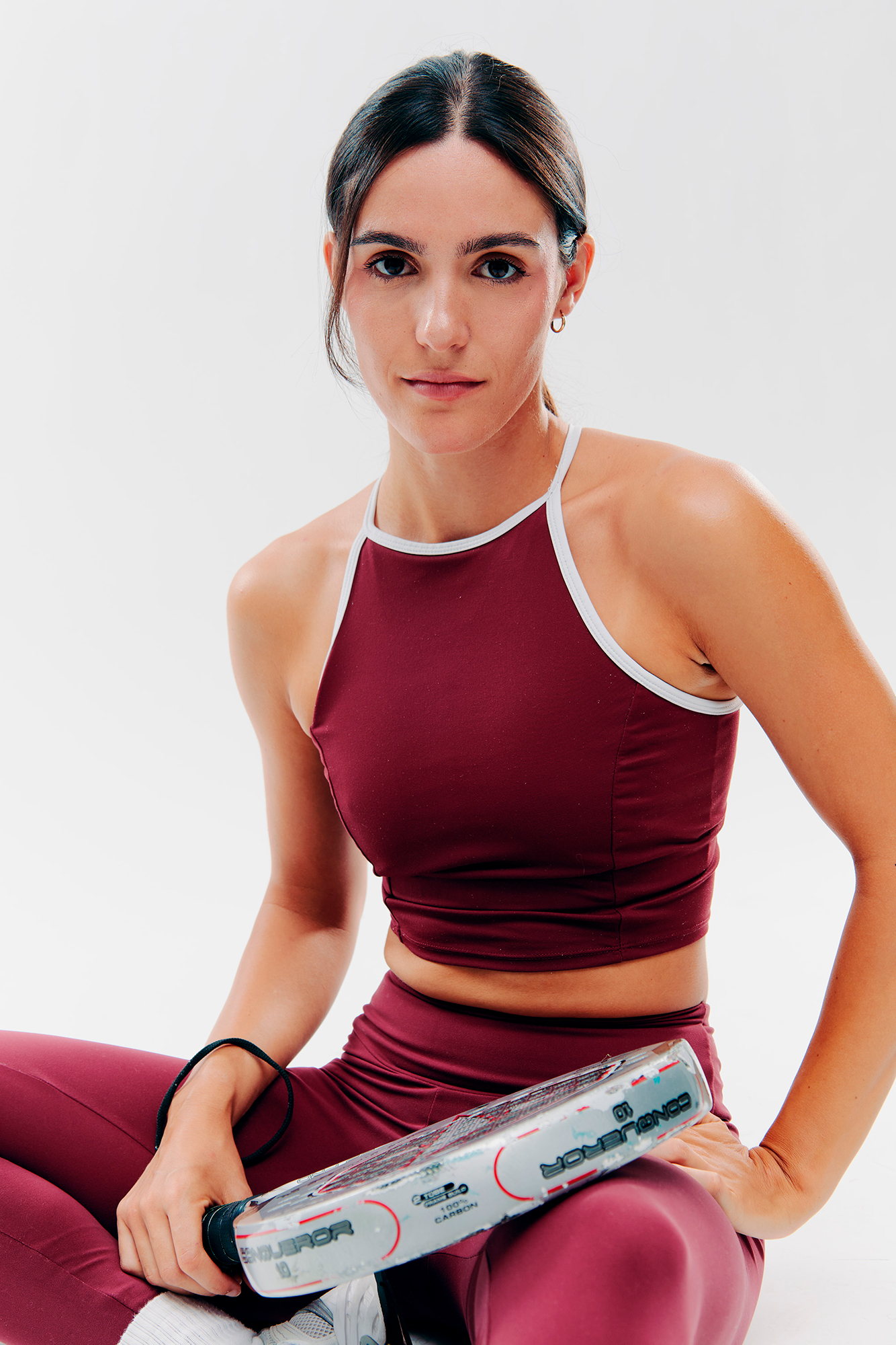 Woman in sportswear holding exercise equipment