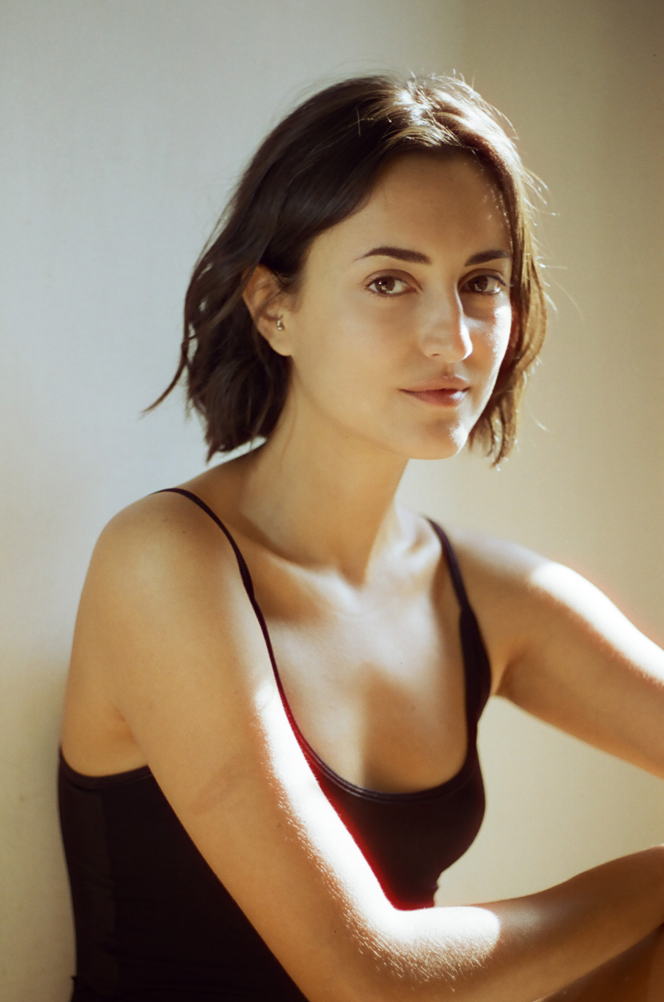Woman in black tank top, natural light.