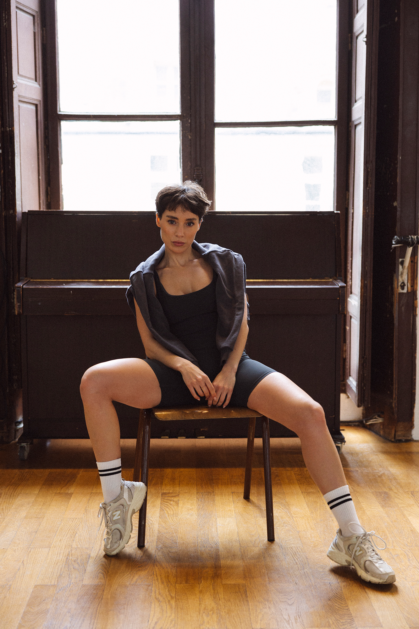 Person sitting on chair in front of piano