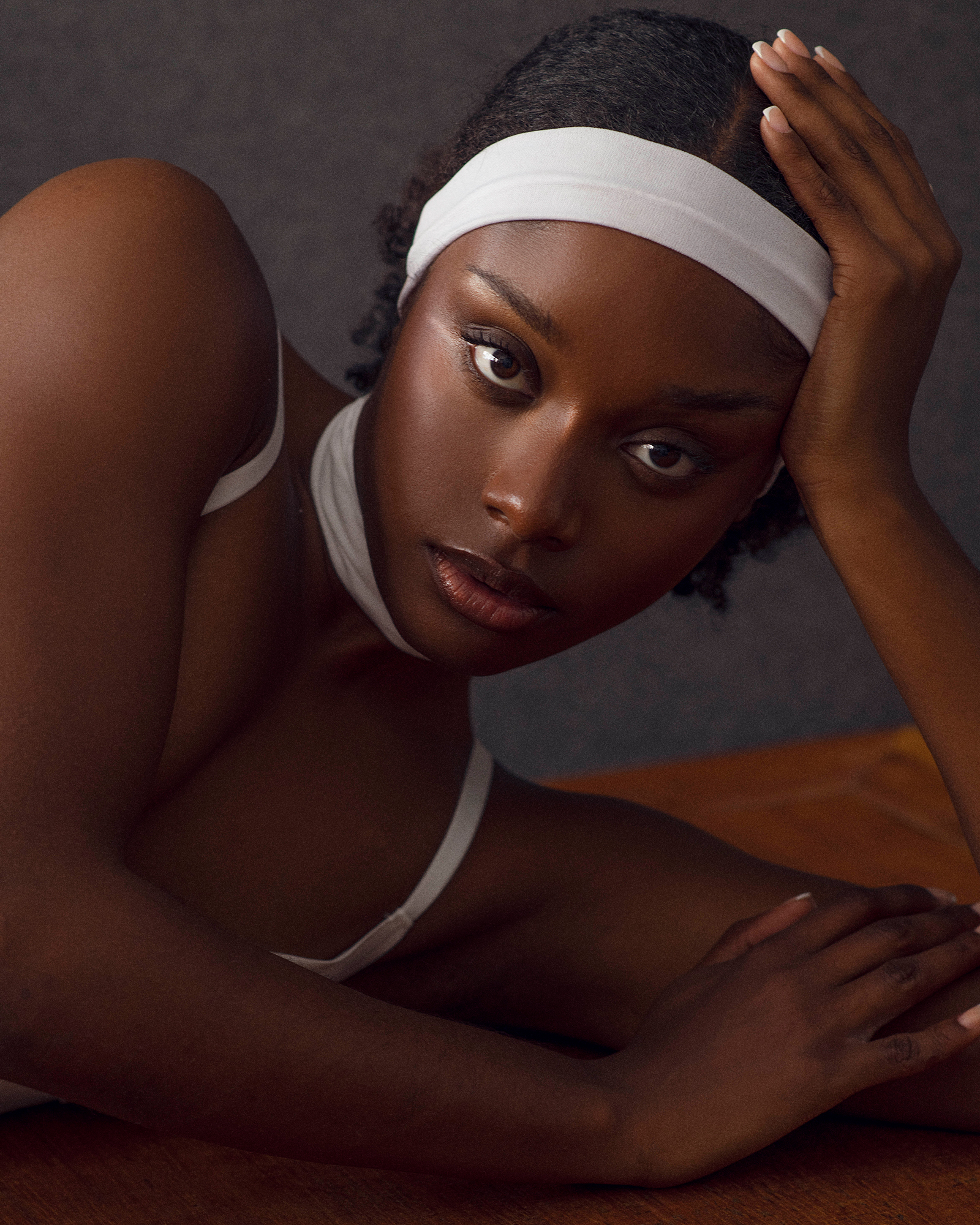 Person with headband resting arm on table