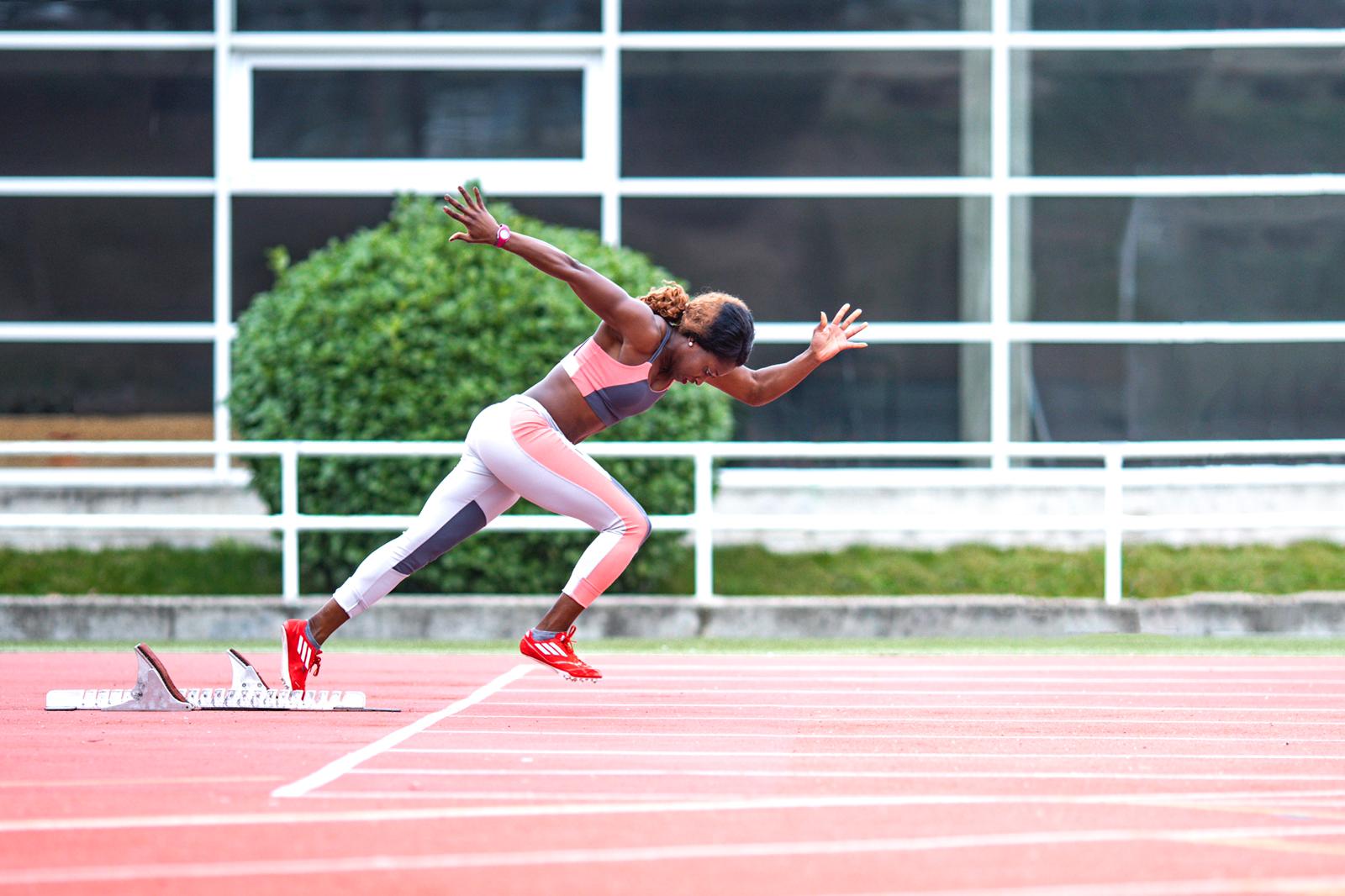 Female sprinter starting on track field