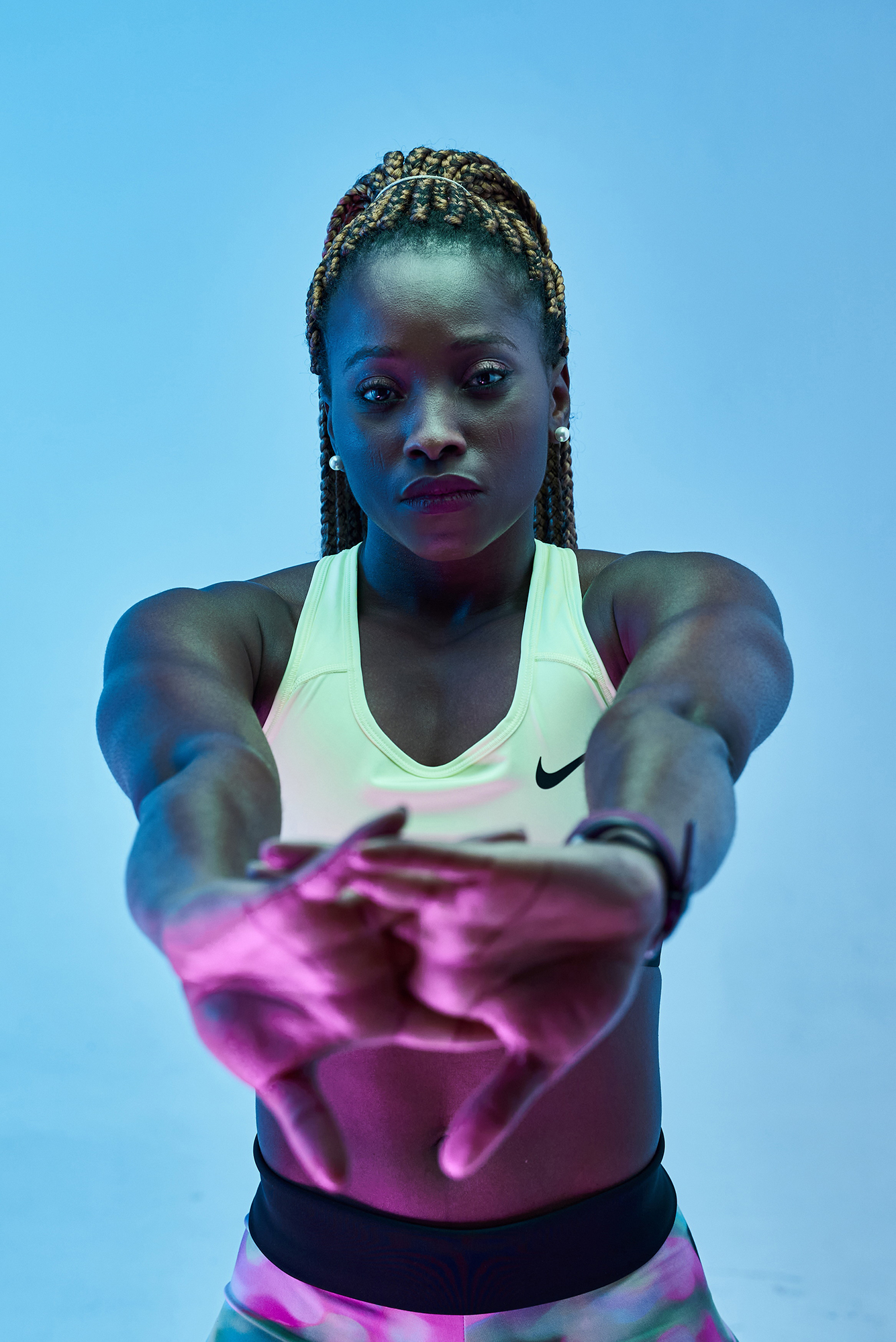 Woman stretching in colorful lighting.