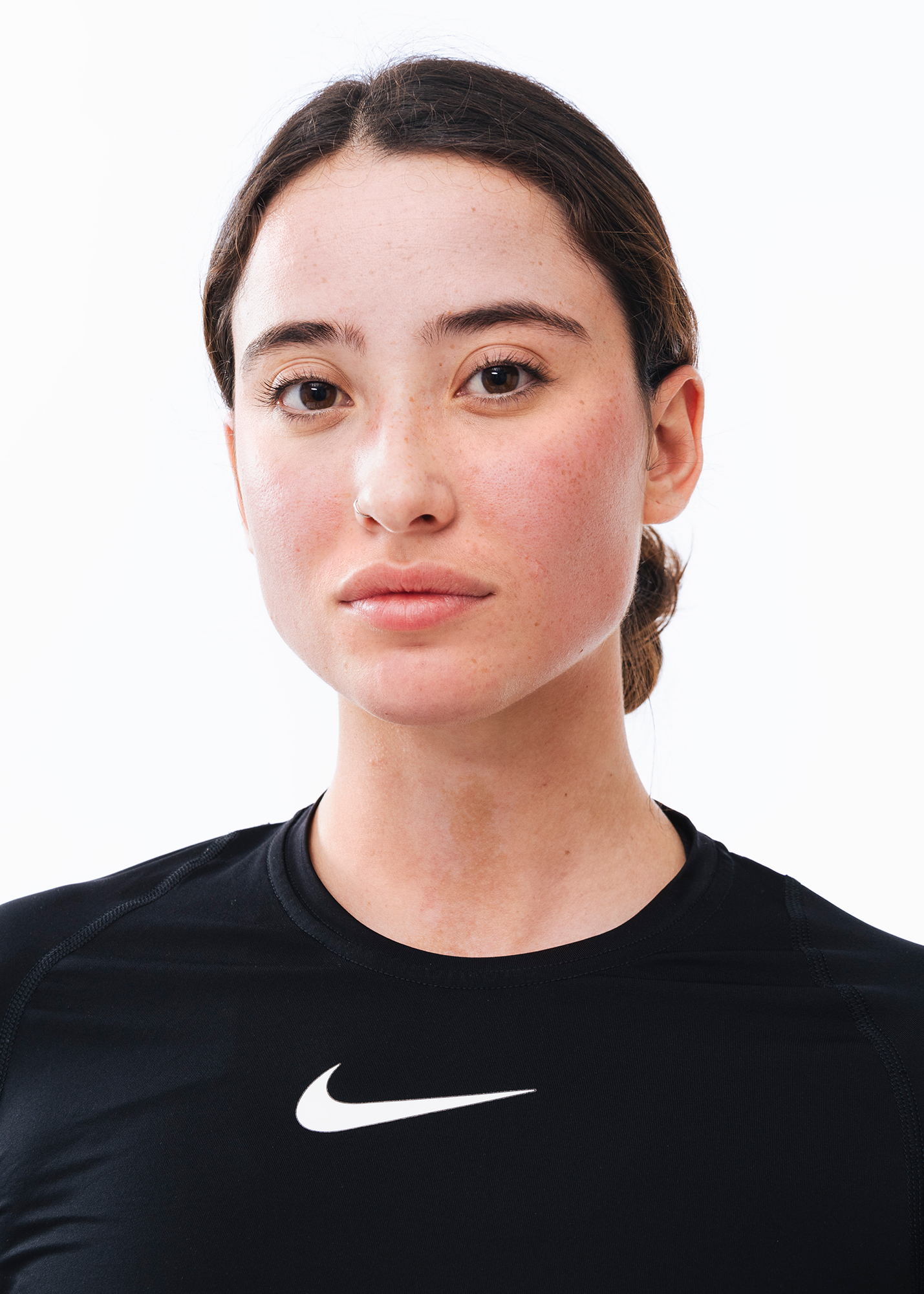 Person in black Nike shirt, neutral expression.