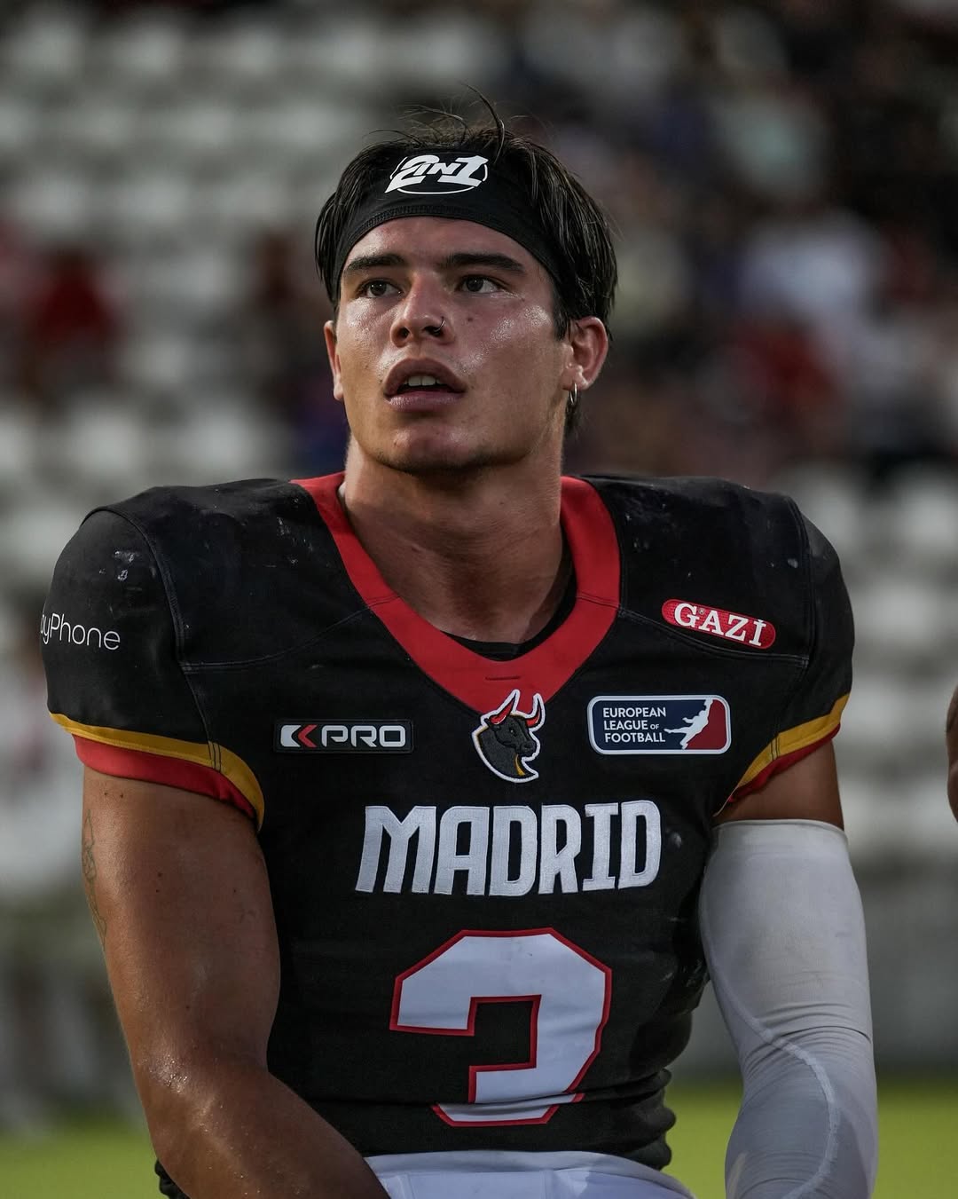 American football player in Madrid jersey, intense expression.