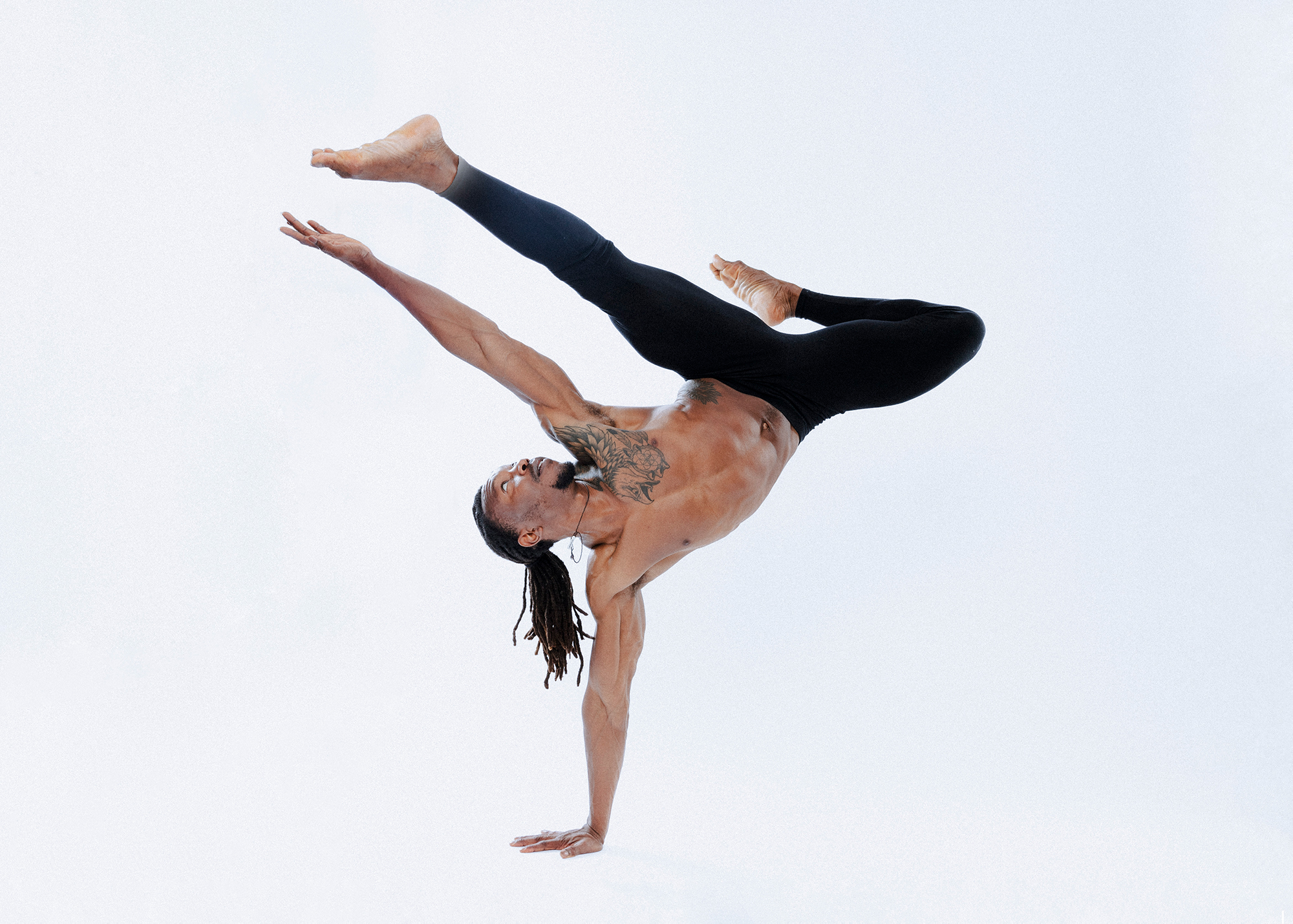 Dancer performing acrobatic handstand pose gracefully.