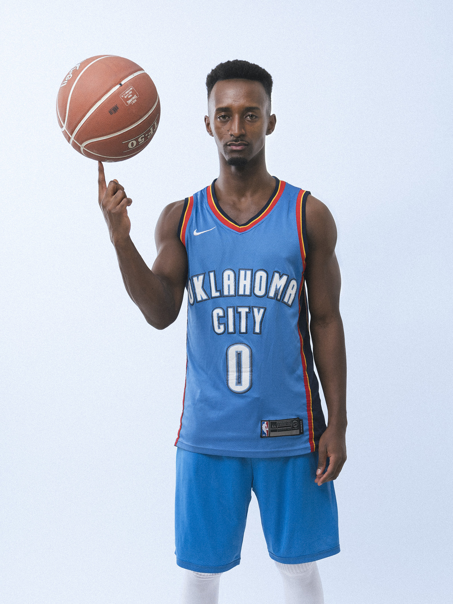 Basketball player spinning a ball on finger.