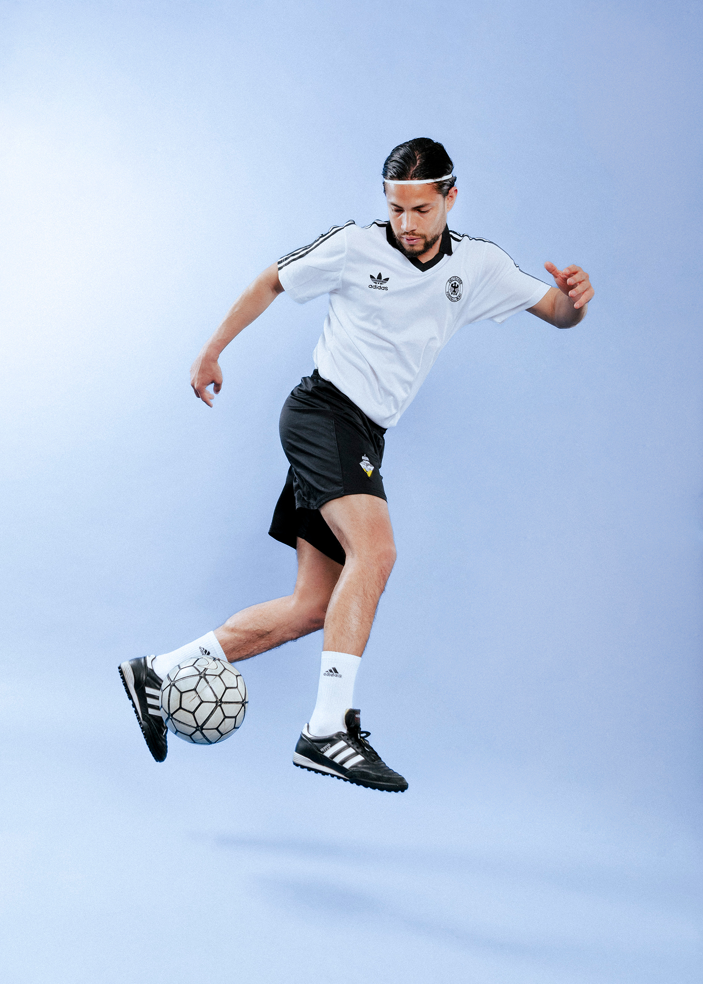 Soccer player juggling ball in mid-air