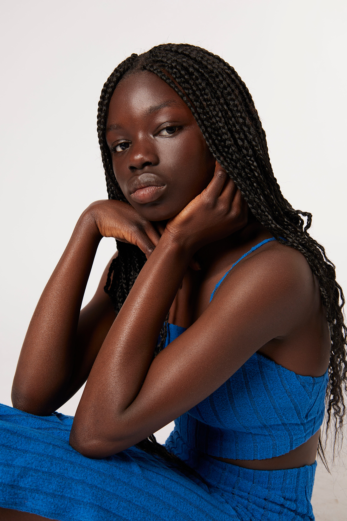Woman in blue dress with braided hair.
