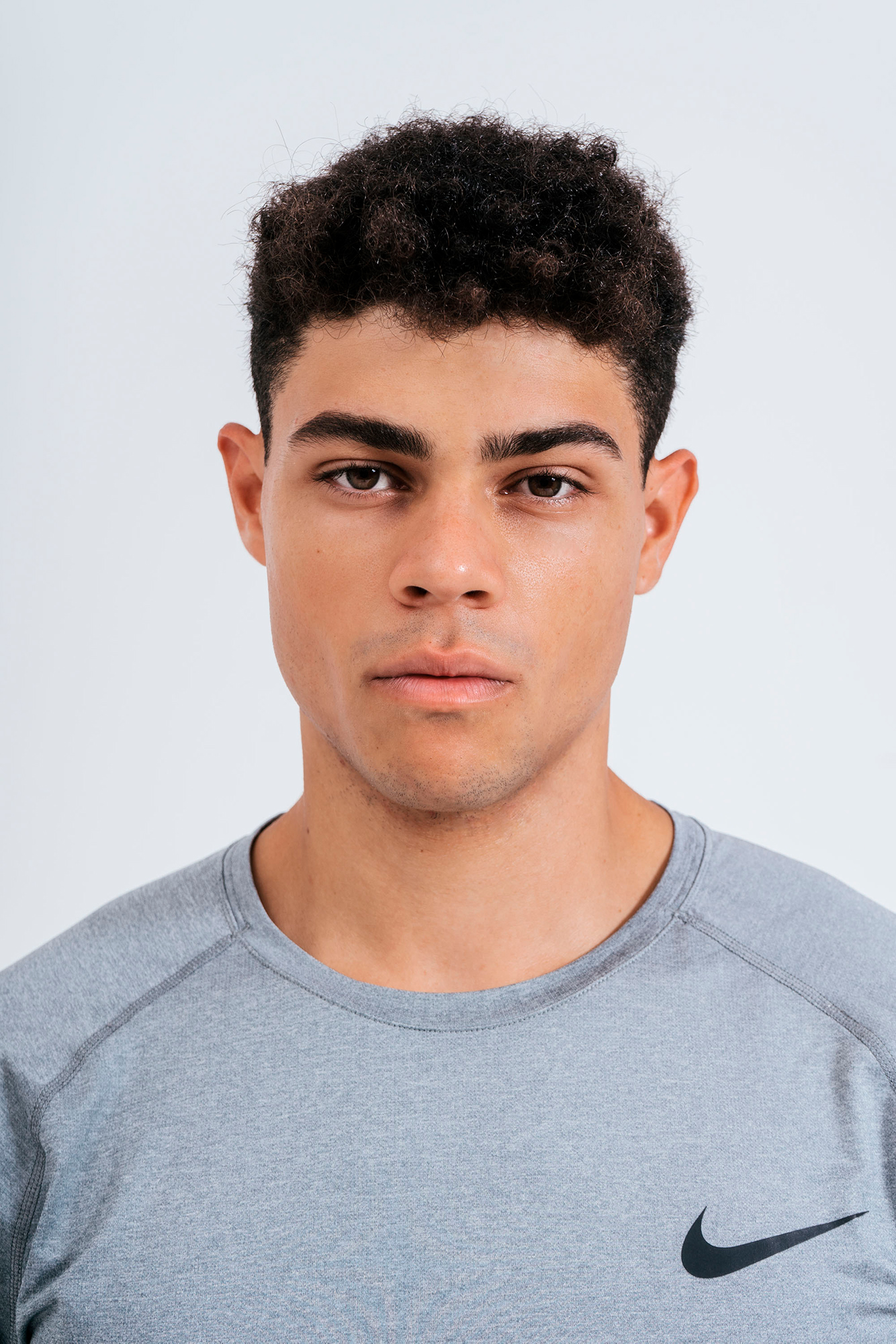 Person in gray Nike shirt front view portrait